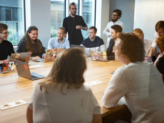 a group of people sitting around a wooden table