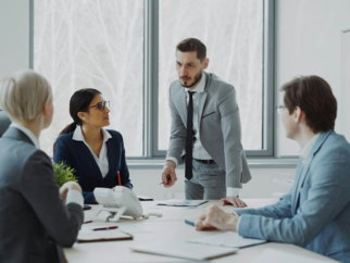 Business professionals in a meeting around a table.