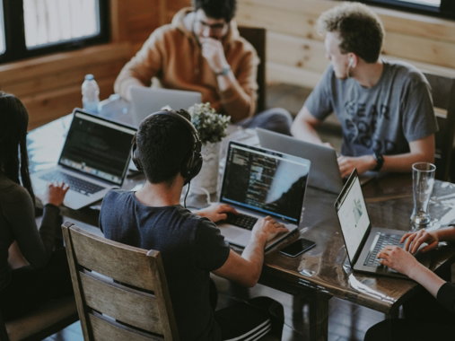 group of people using laptop computer