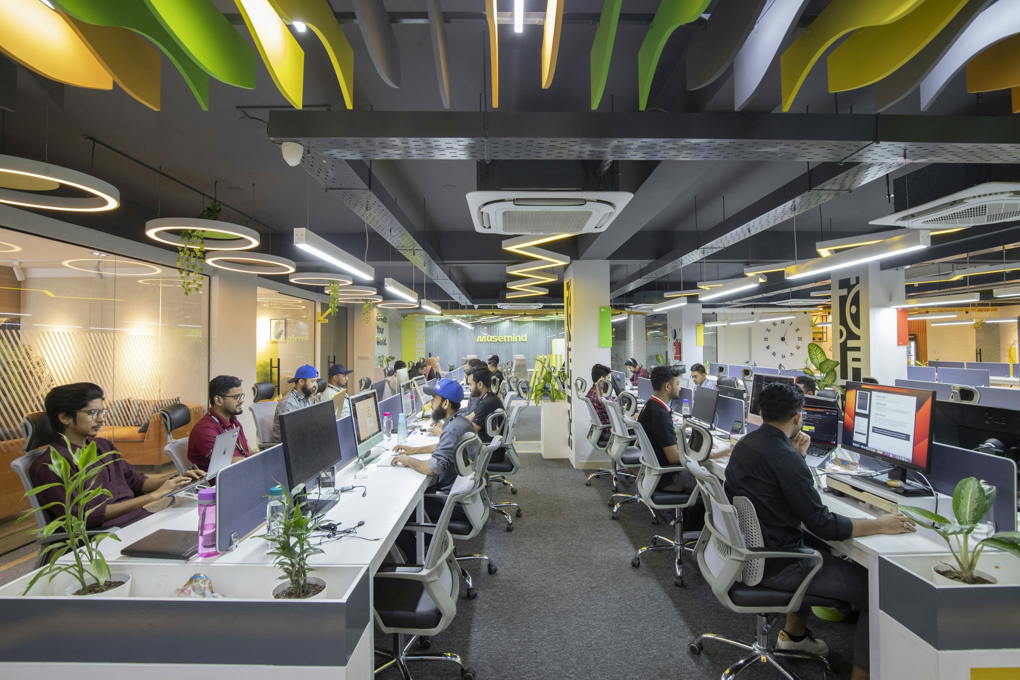 a-group-of-people-sitting-at-desks-in-an-office.jpg a group of people sitting at desks in an office